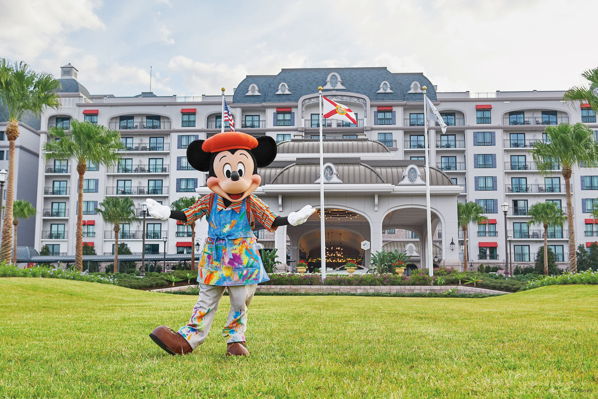 Disney's Grand Floridian Resort & Spa, a stately Victorian beach resort, on the shore of a lake lined with palm trees